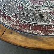 Vintage wooden turned coffee table with leather and astrological decoration.