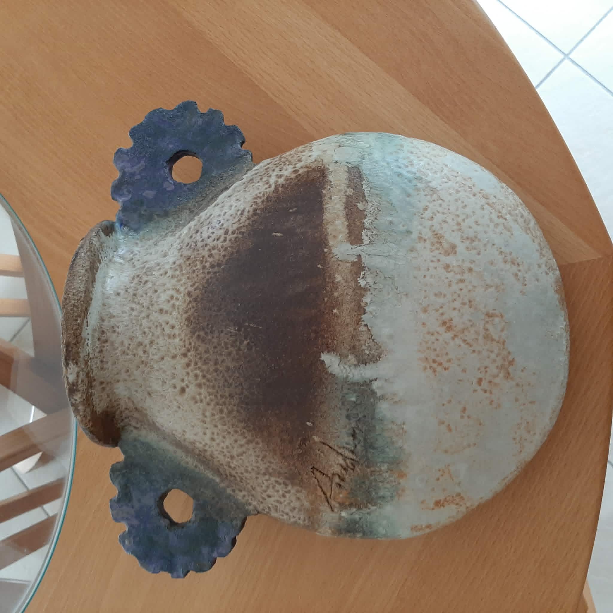 Oval/round pottery on base signed