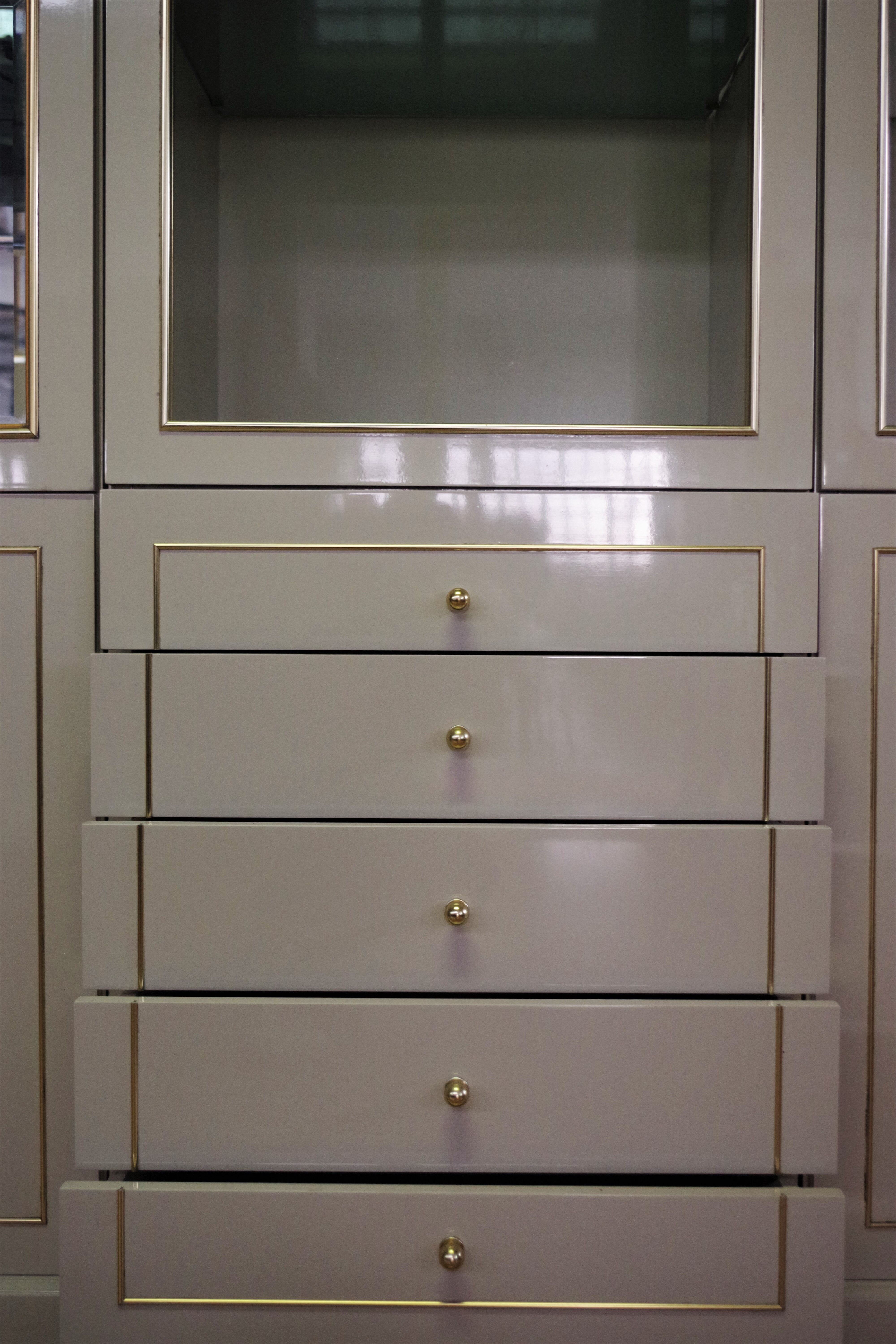 Showcases in lacquered wood, glass and brass  1970s, set of 4