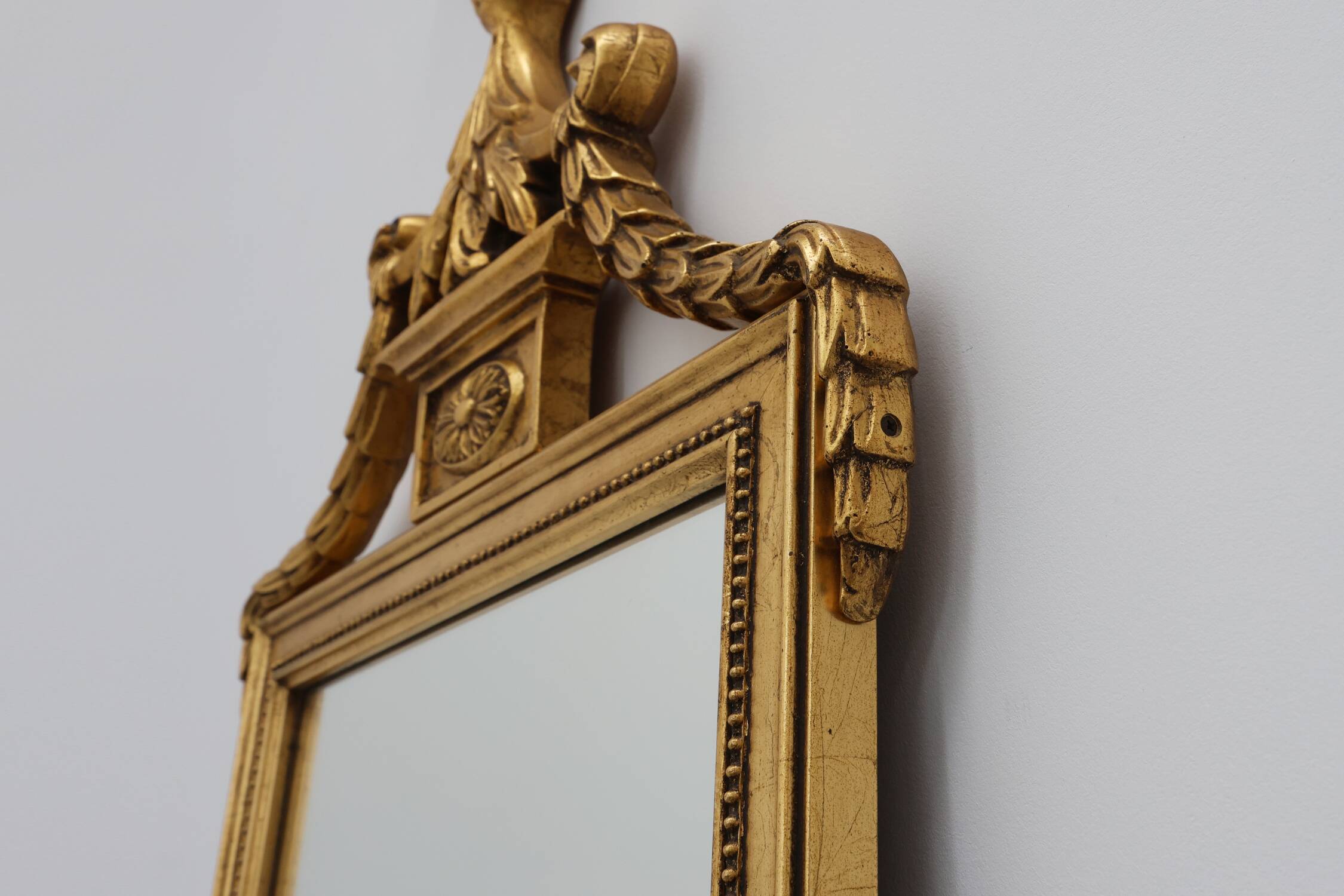 20th Century gilded wooden Empire style mirror with eagle on top