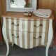 Curved commode with beige and white stripes.