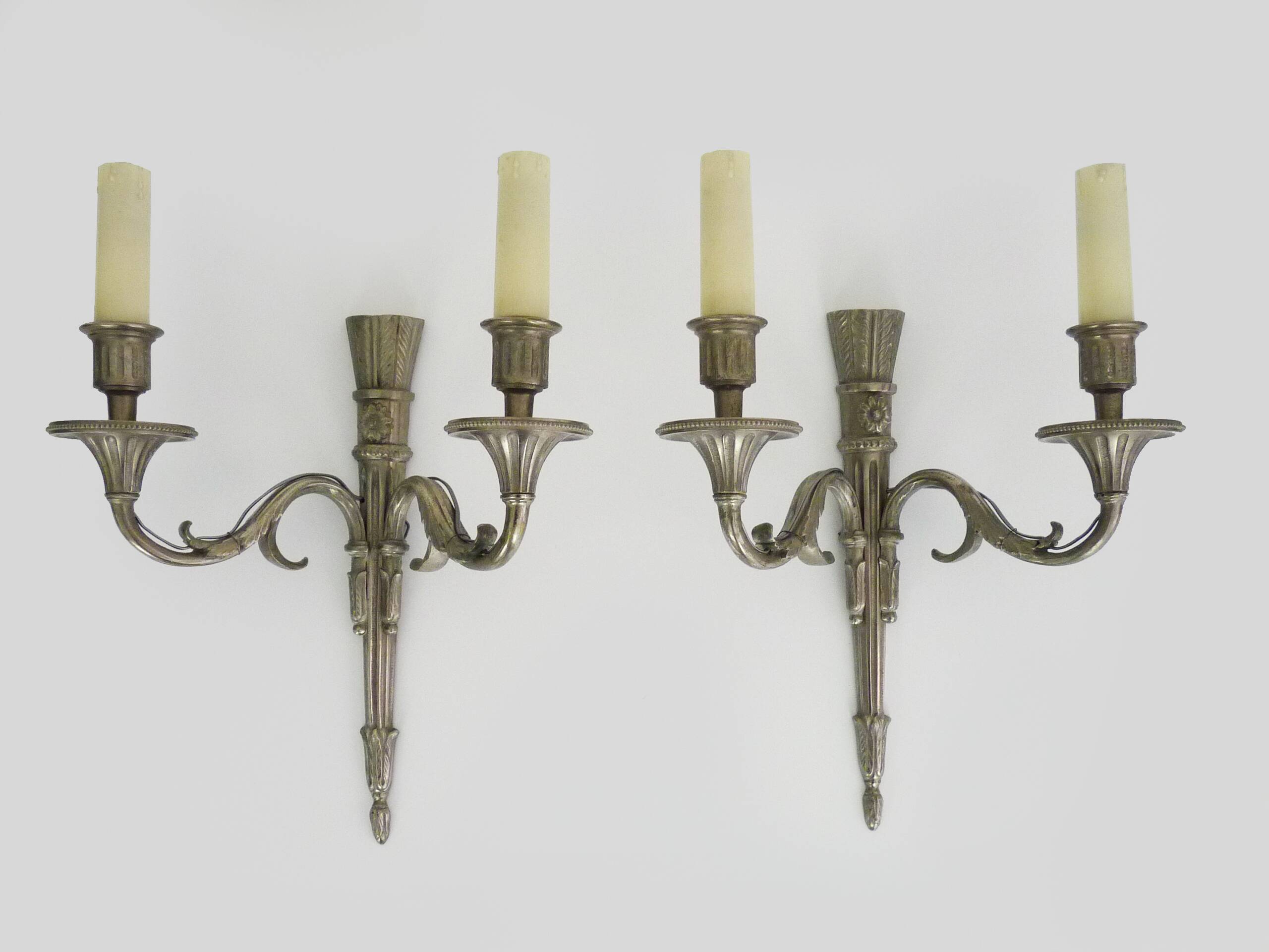 Pair of empire style double light wall lights in silvered bronze. the 50's