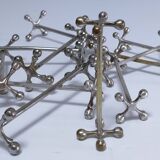 Eleven 70s design metal "crosshair" knife holders