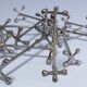 Eleven 70s design metal "crosshair" knife holders