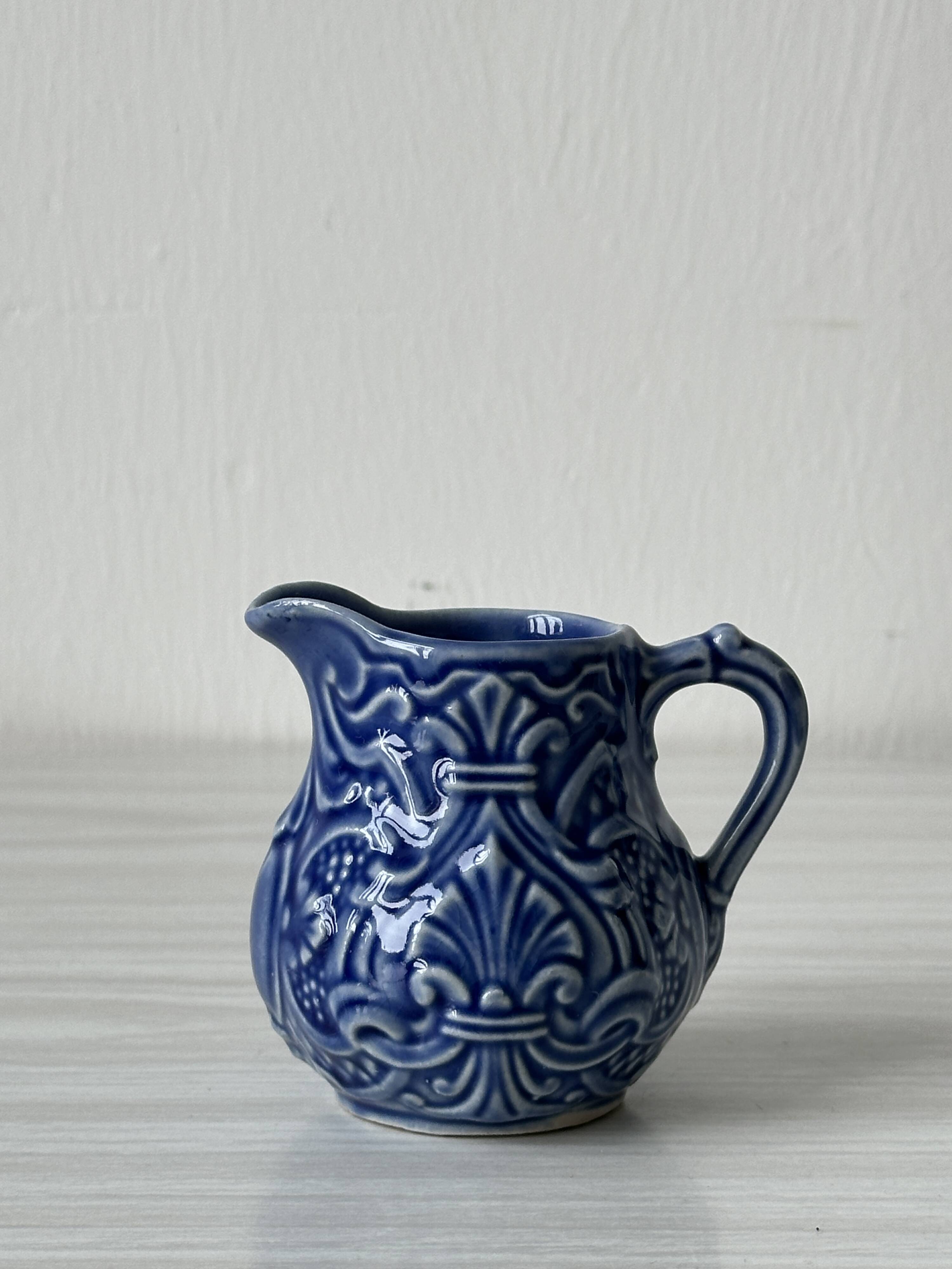 Old cream milk jug in slip