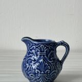 Old cream milk jug in slip