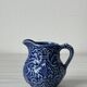 Old cream milk jug in slip