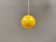 Spherical pendant lamp in sunny yellow.