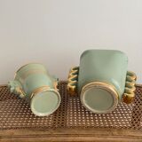 Two green and gold vases with handles