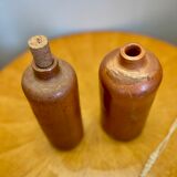 Set of two bottles or jugs in ocher-brown enamelled sandstone
