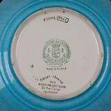 Longwy plate with polychrome enamels, decorated with the "City of Iron" motif.