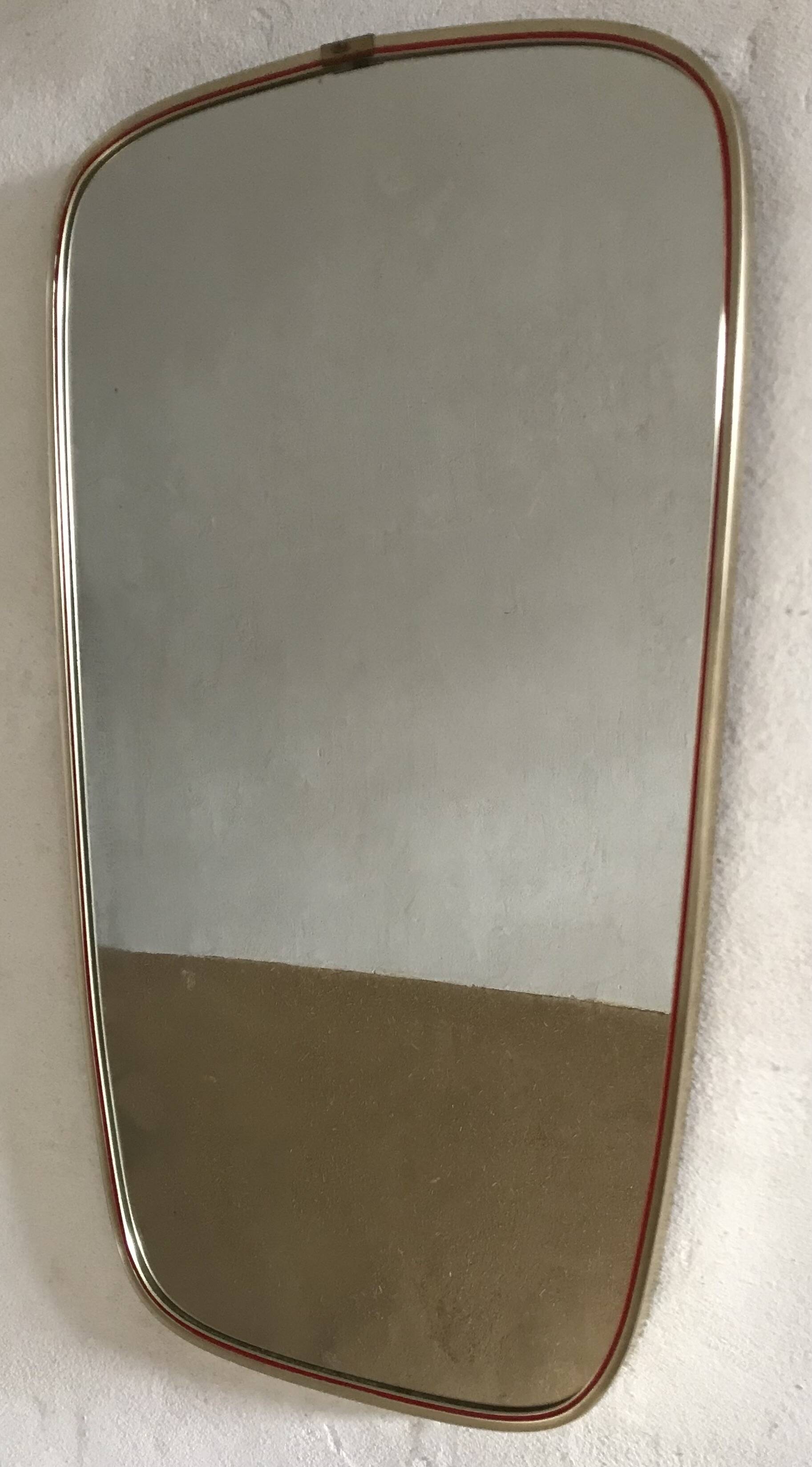 Vintage 1960s mirror in a freeform shape with a gold and red trim.