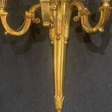 Pair of gilt bronze wall sconces with three lights in the Louis XVI style.