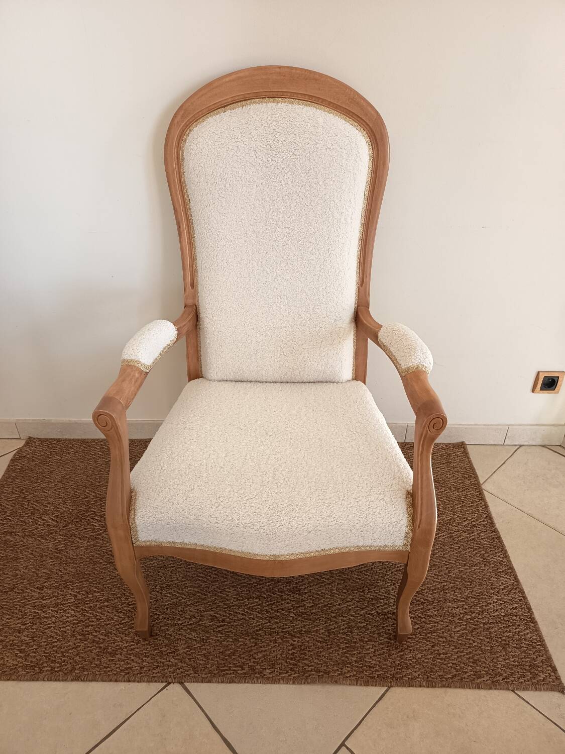 Renovated Voltaire armchair with boucle fabric.