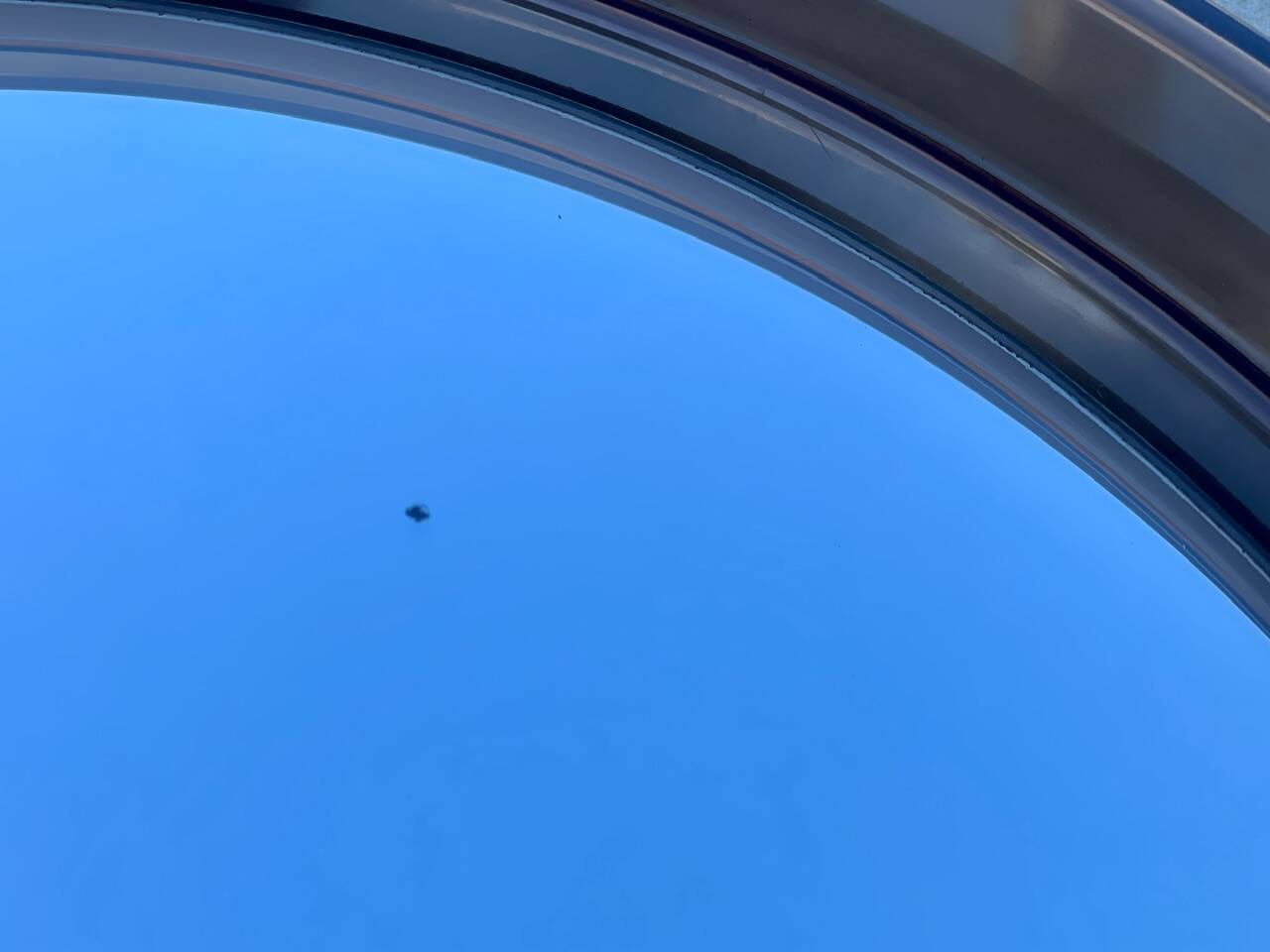 Vintage round smoked plastic mirror, circa 1970s.