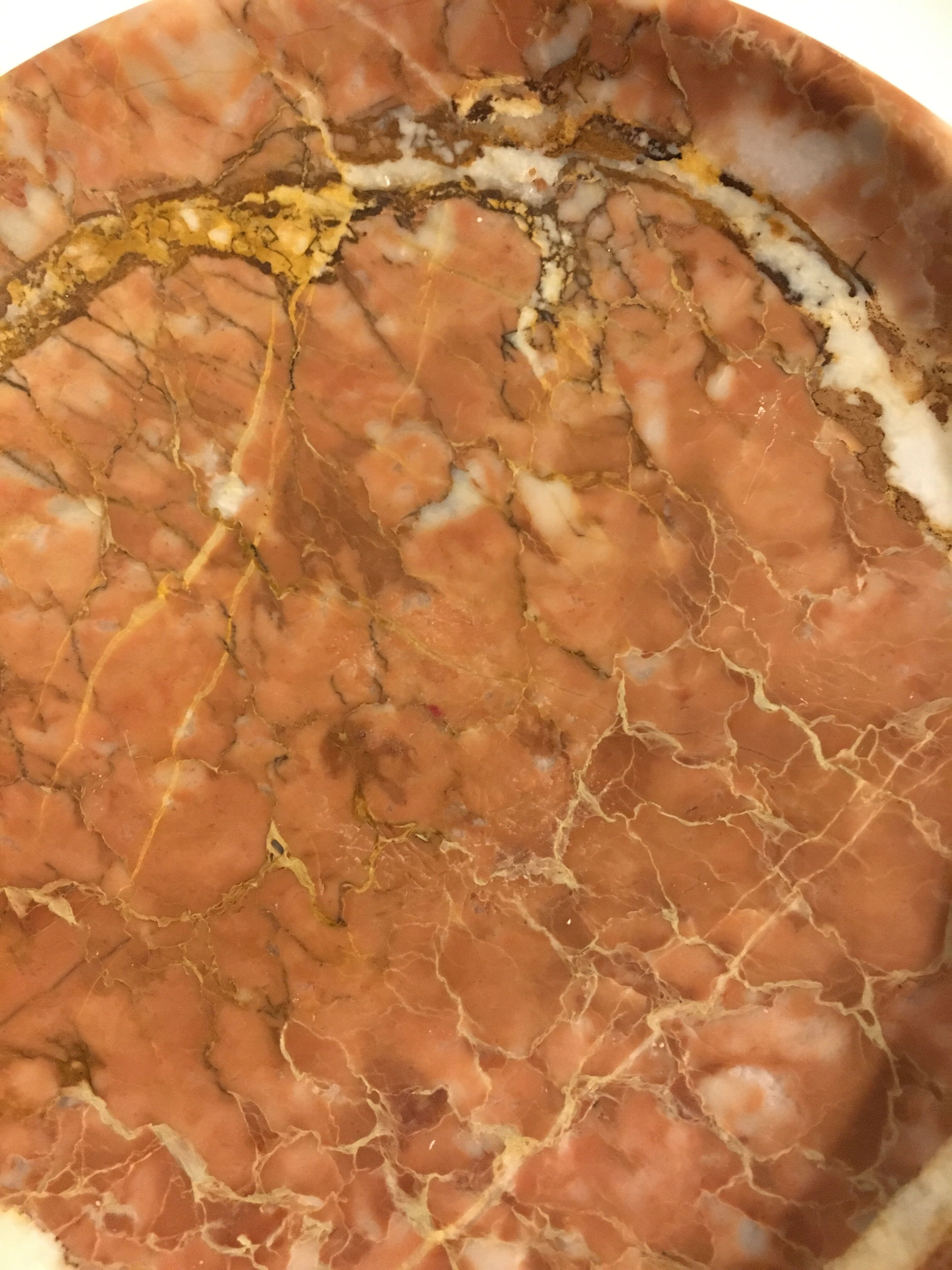 Empty pocket on foot in red marble