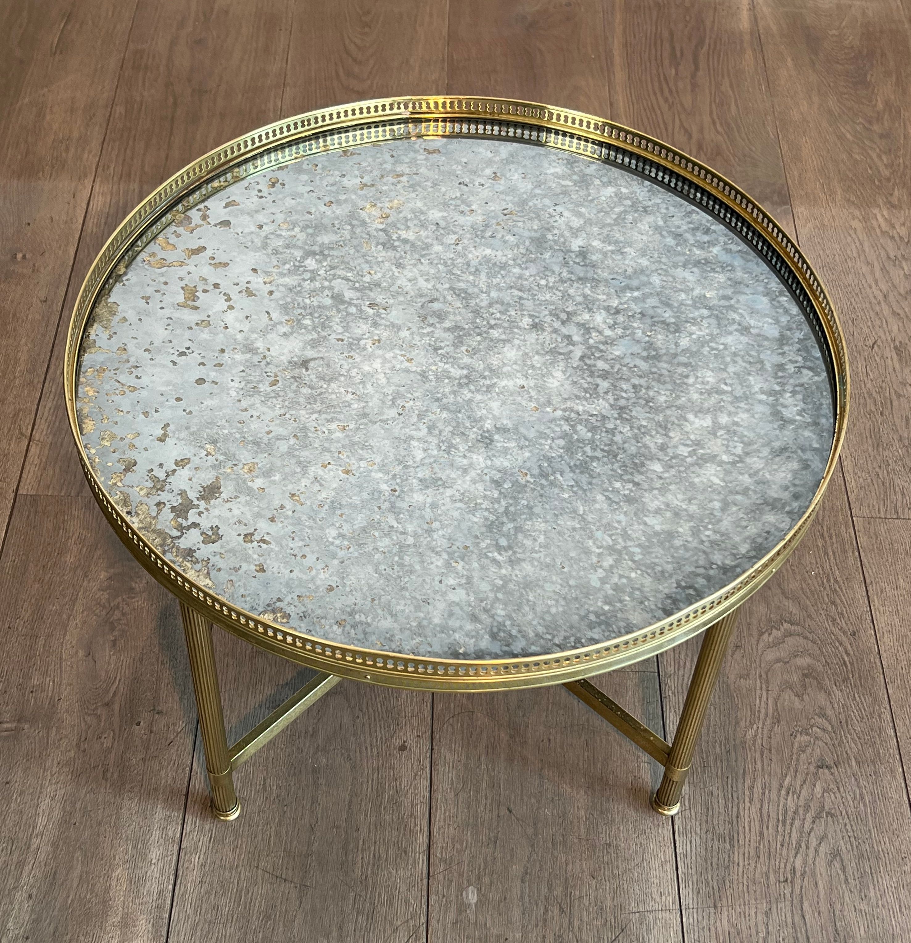 Brass coffee table with a vintage mirror top from the Baguès house.