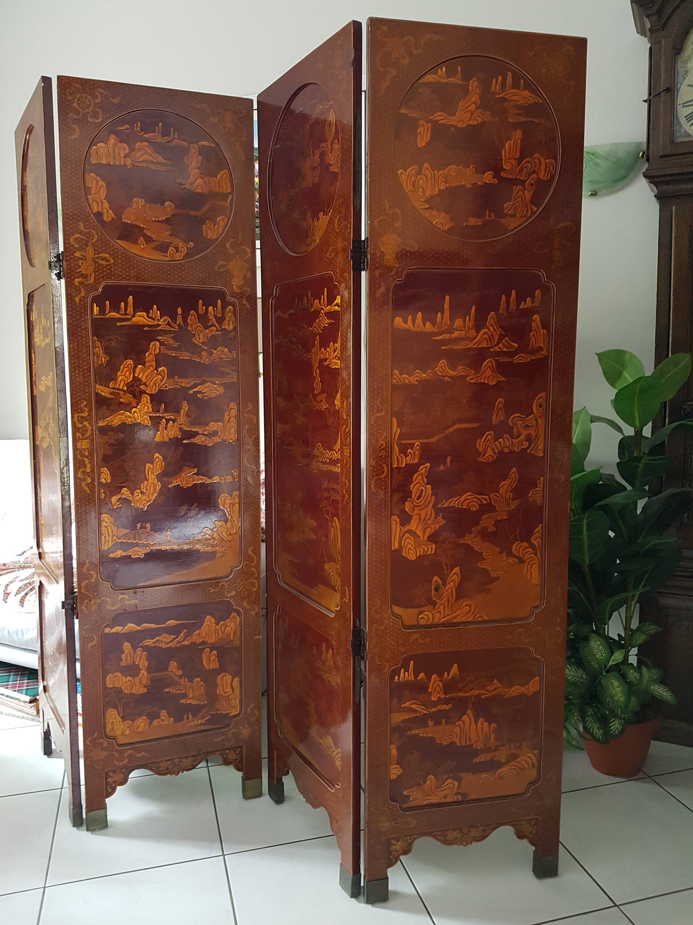 Four-panel Japanese-style screen in red and gold lacquer.