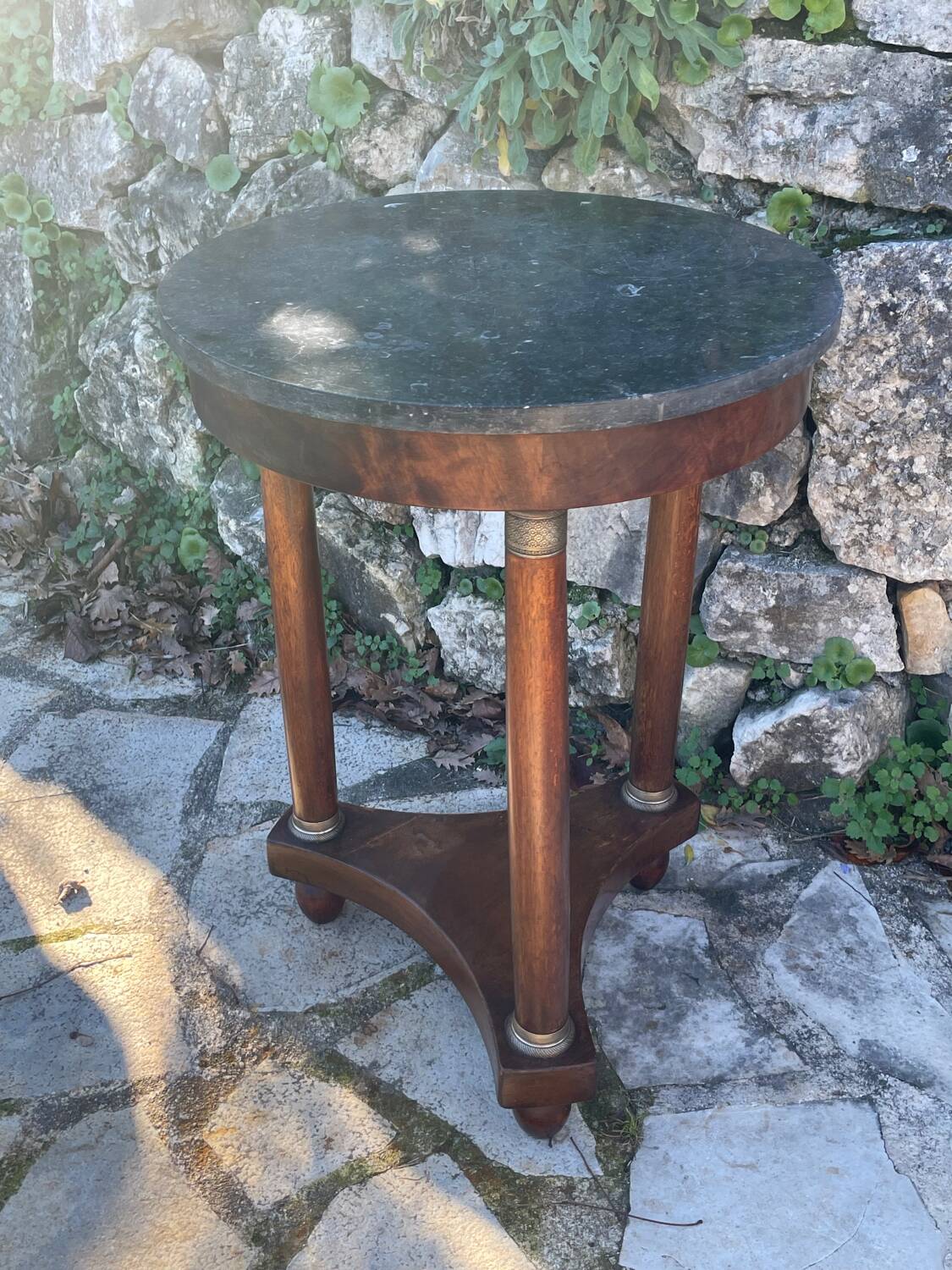Empire style mahogany and mahogany veneer tripod pedestal table