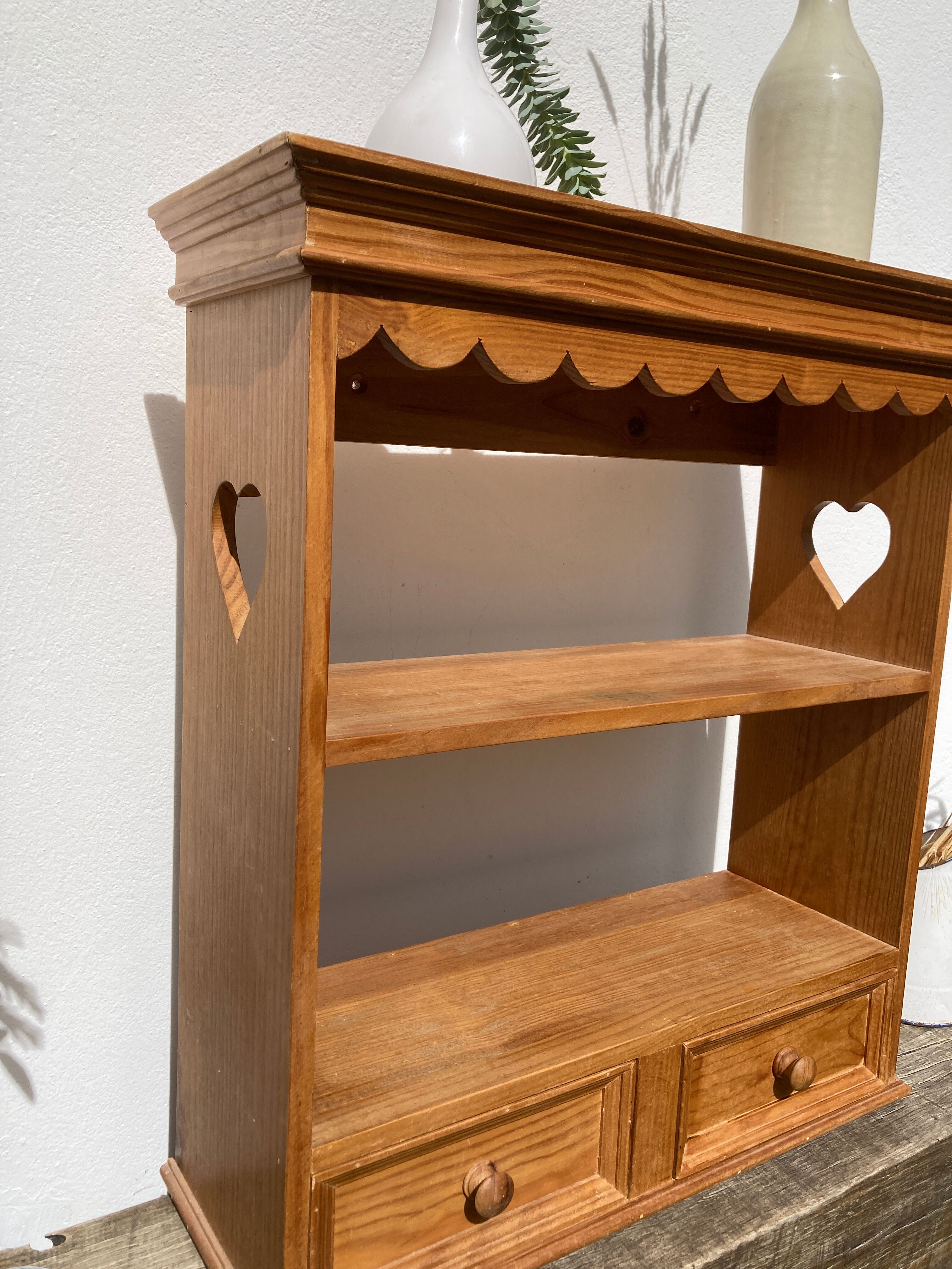 Wall shelf in raw wood with drawers and openwork hearts