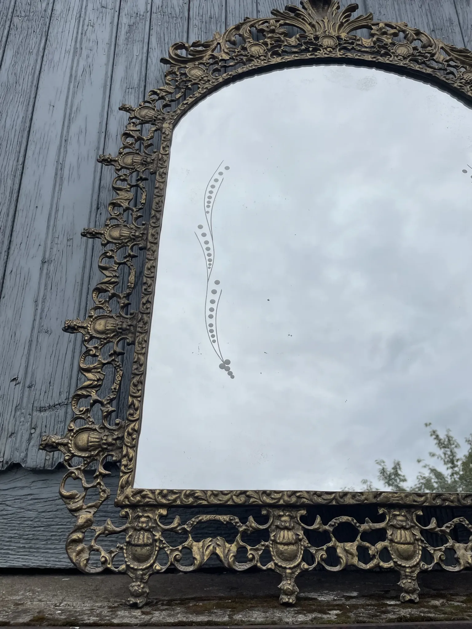 Vintage brass wall mirror adorned
