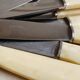 12 ivory & stainless steel bakelite knives in their case