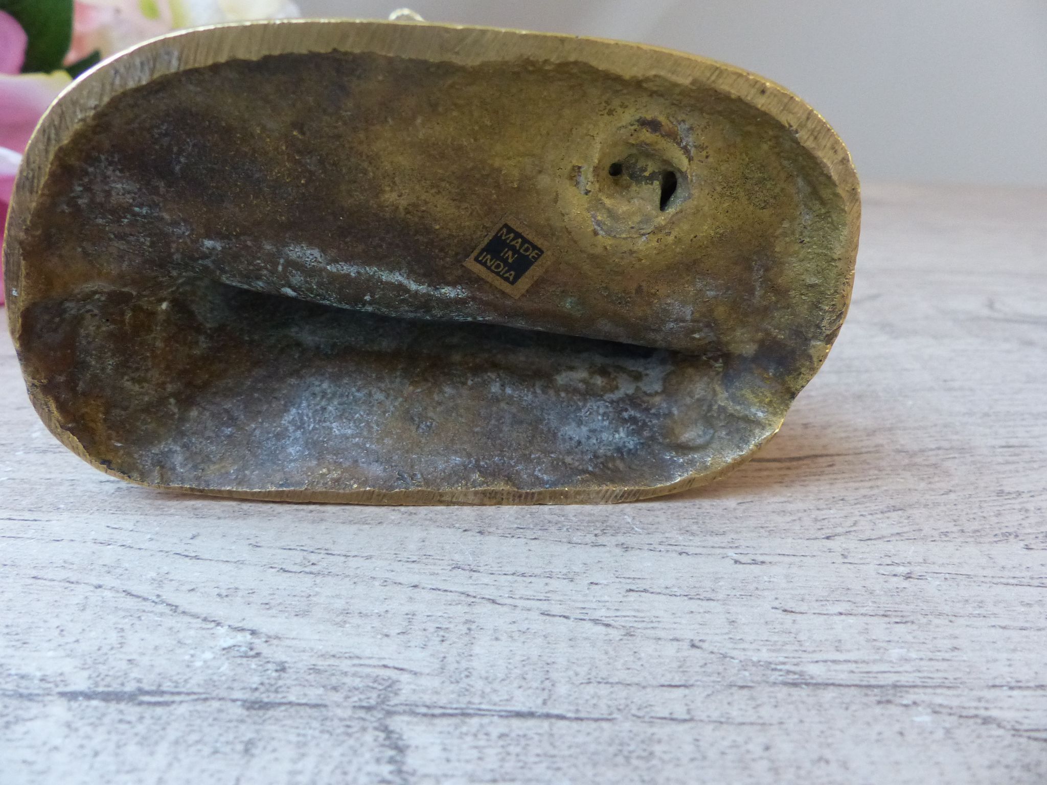 Golden brass cat figurine on fence looking at a mouse in a Vintage India shoe