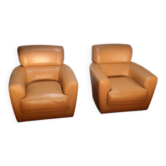 Pair of leather club armchairs: Roche and Bobois.