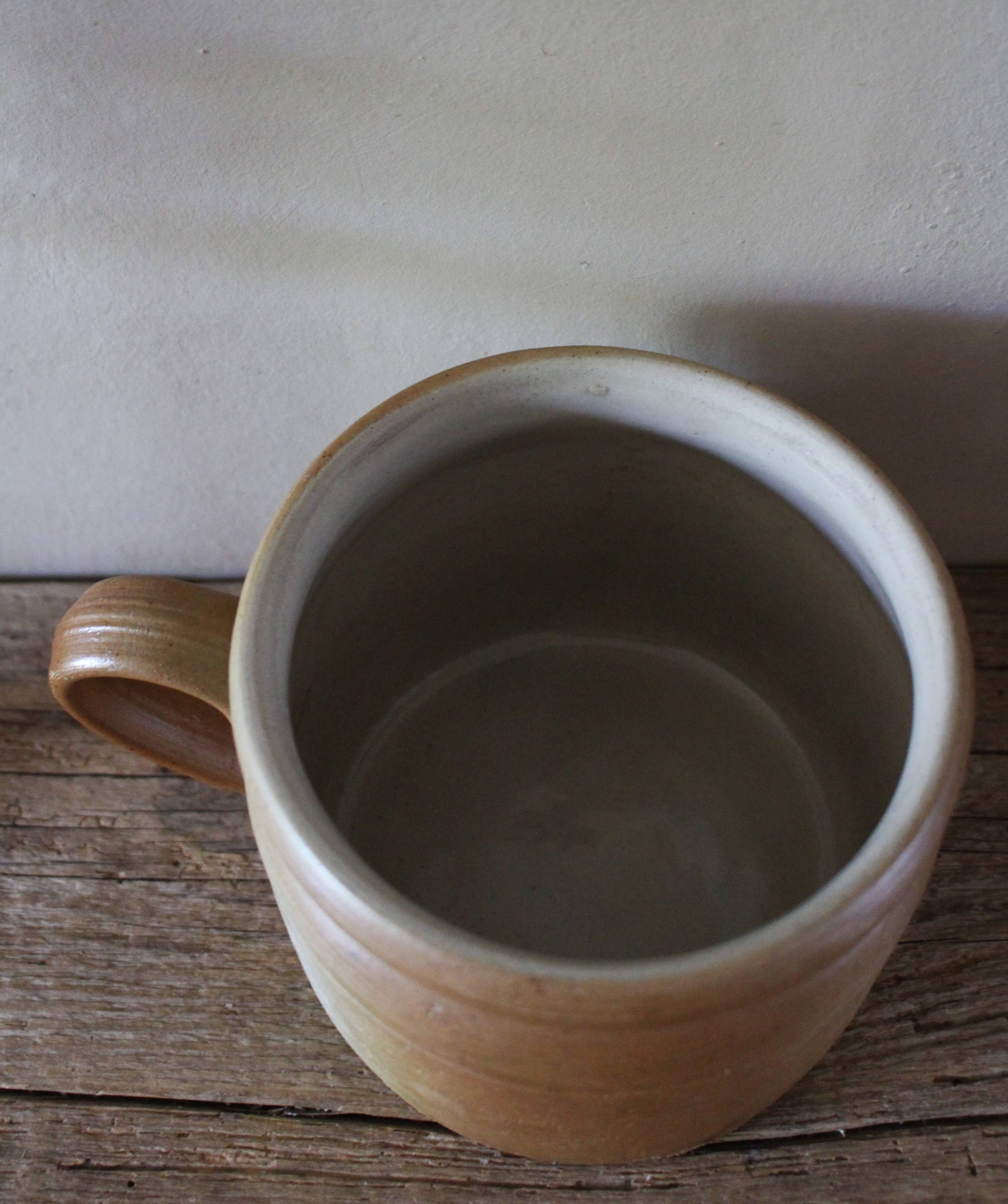 Vase terracotta milk jug with a glazed interior handle.