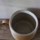 Vase terracotta milk jug with a glazed interior handle.