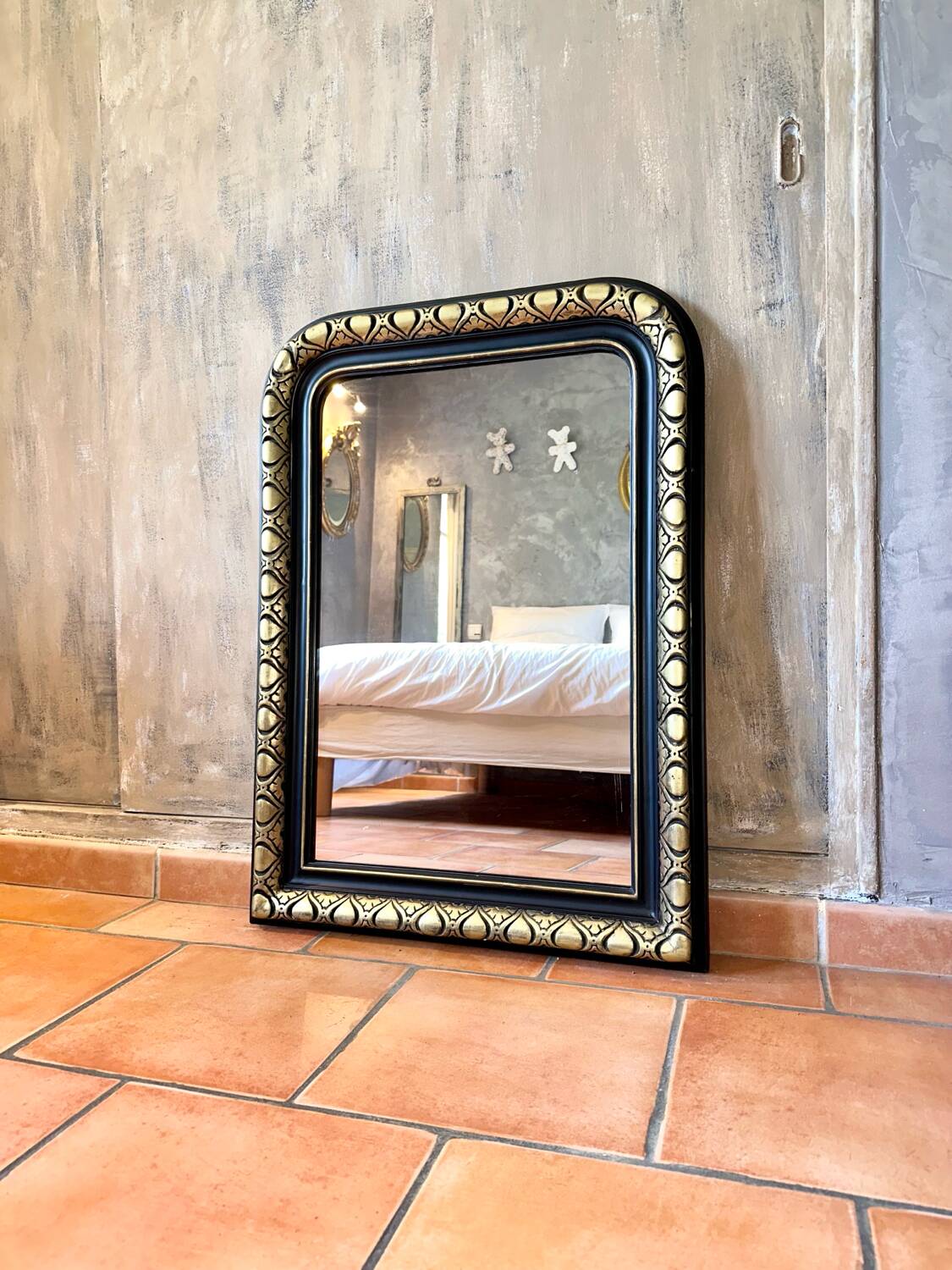 Louis-Philippe black and gold antique mirror from the 19th century