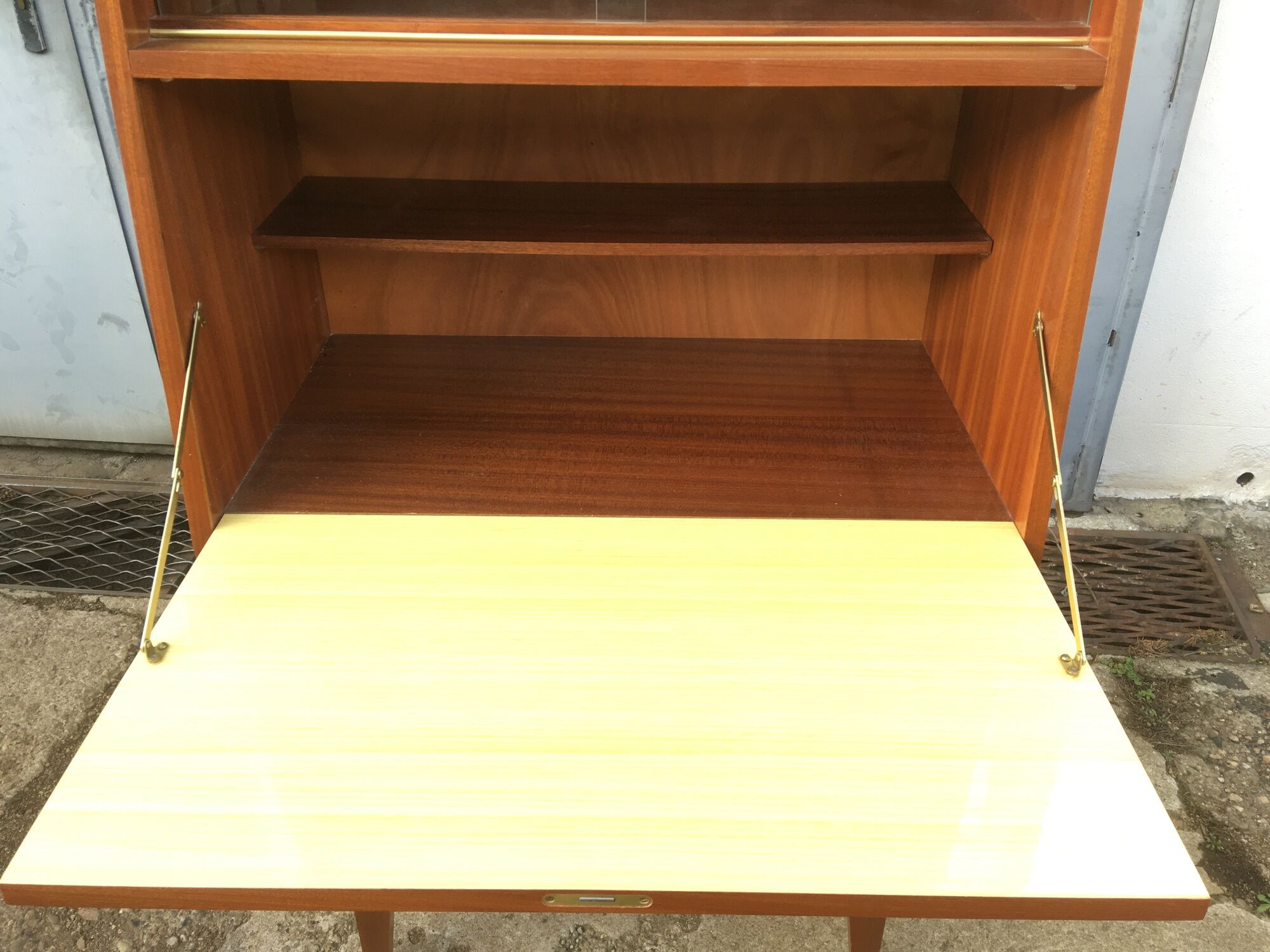 Vintage secretary with wooden compass feet with felling, shop window and closet