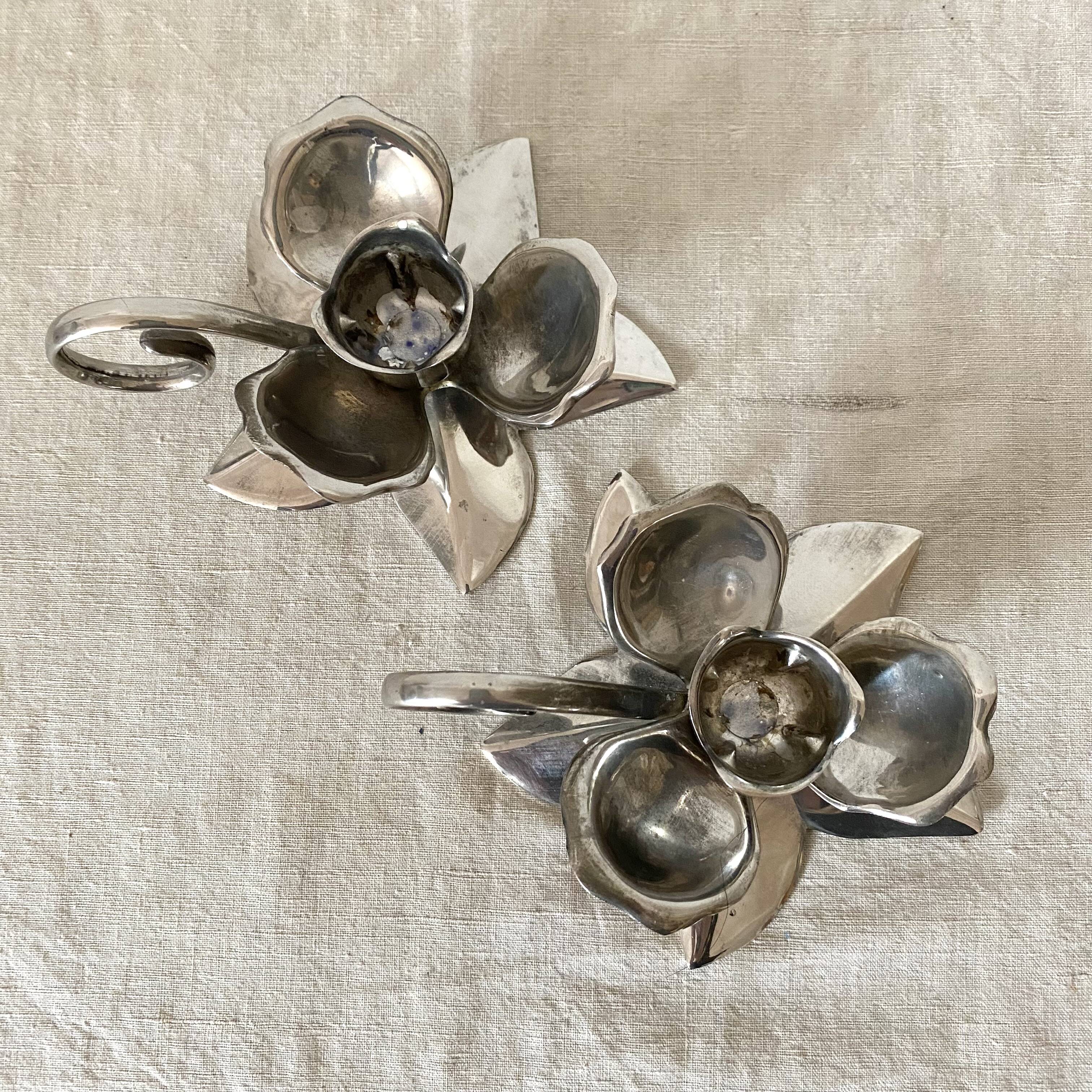 Pair of silver metal flower candle holders