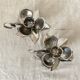 Pair of silver metal flower candle holders