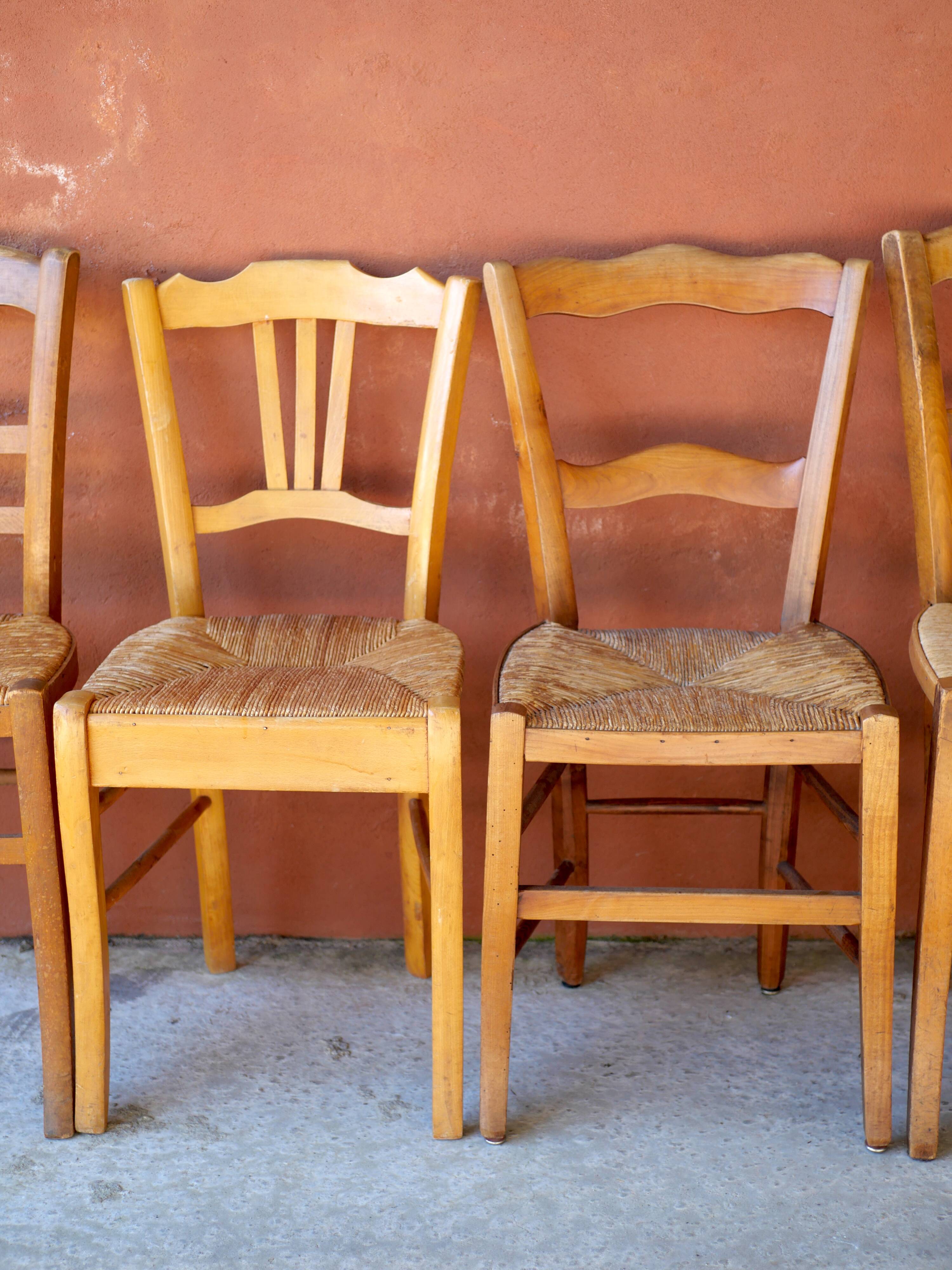 Set of 5 mismatched straw chairs.