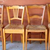 Set of 5 mismatched straw chairs.