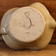 Signed sandstone candle holder