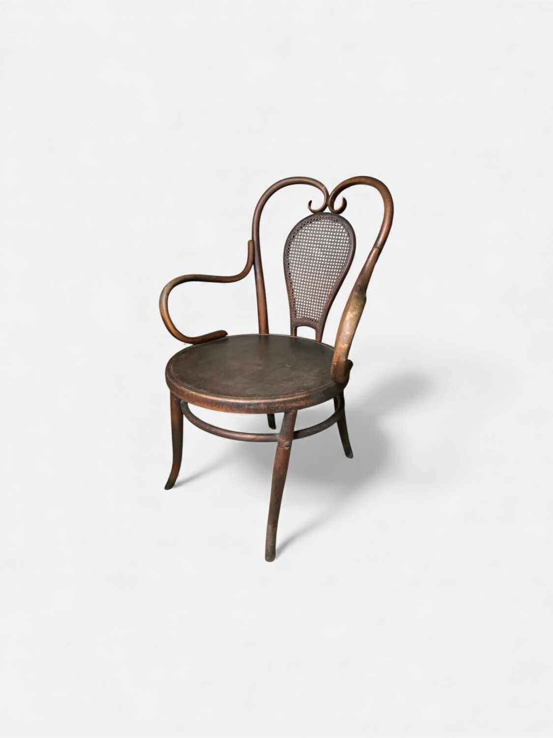 Antique curved wooden armchair with caning – Bistro style