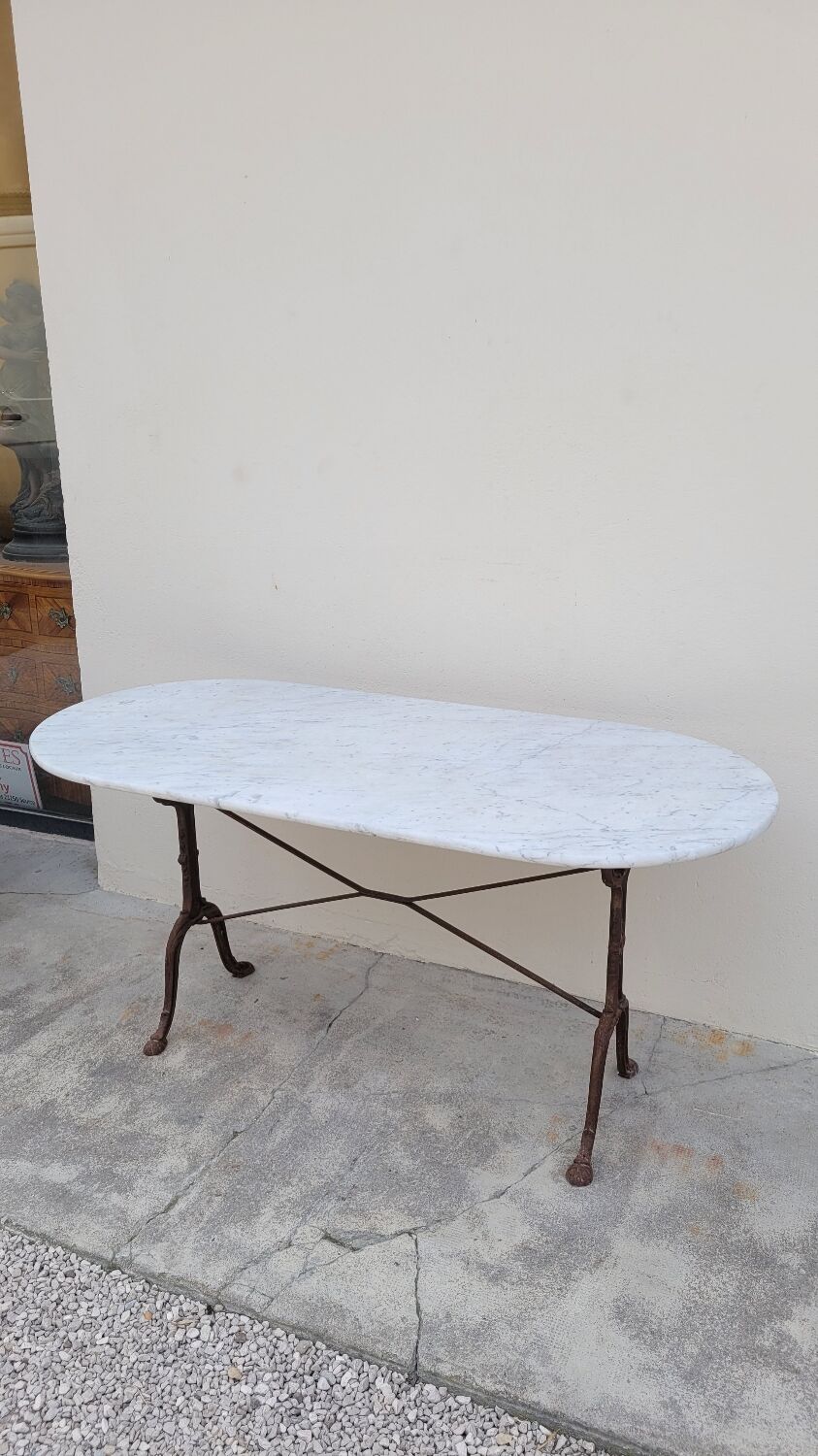 Restaurant bistro table in oval marble and decorated cast iron bases -1m51