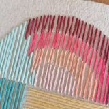 Rainbow embroidery on rag paper