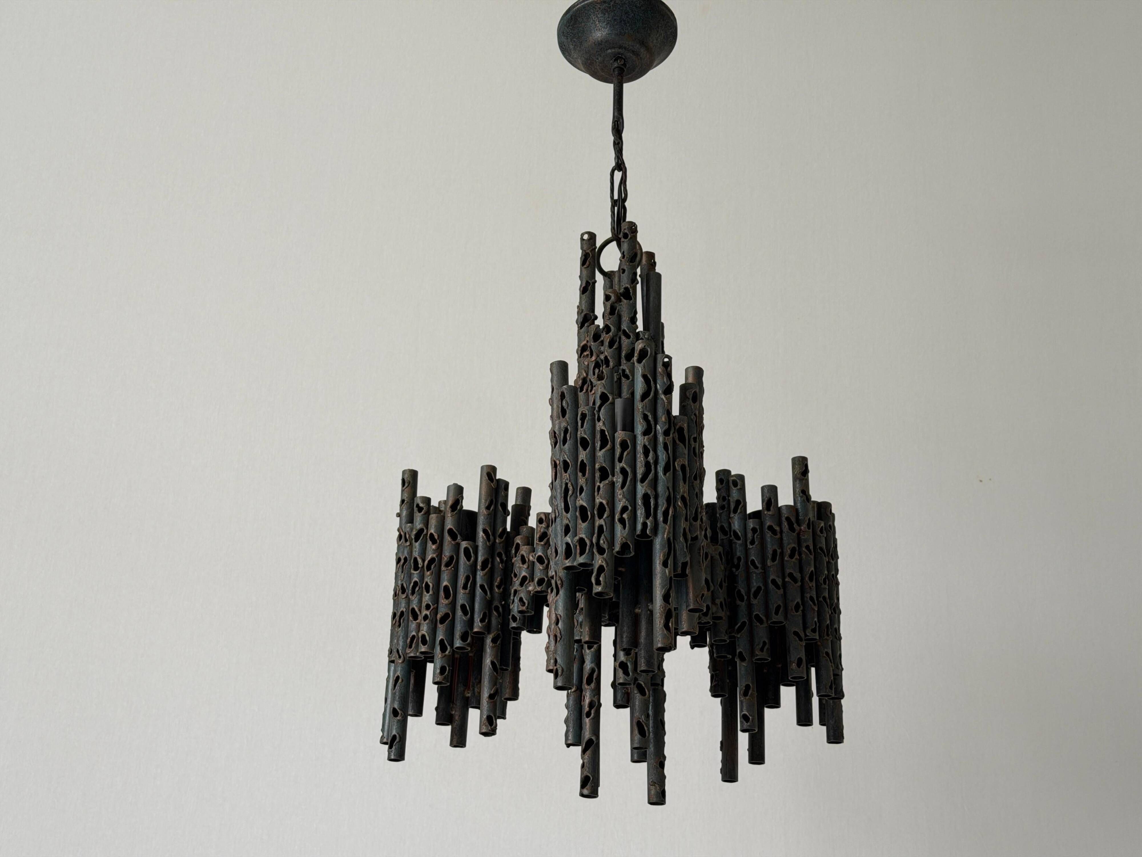 Three-armed suspended lamp in wrought iron, brutalist design, 1960s, Italy.