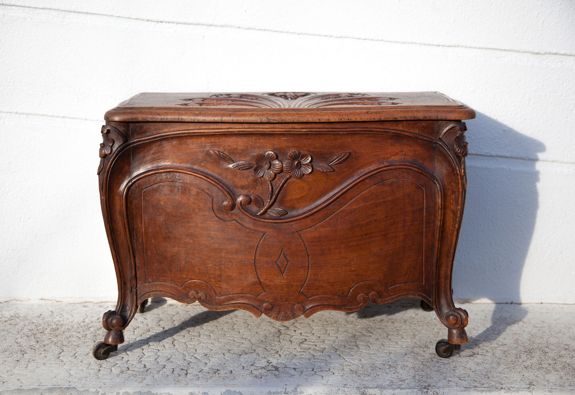 Old chest, carved wooden chest, curved chest on wheels, interior decoration