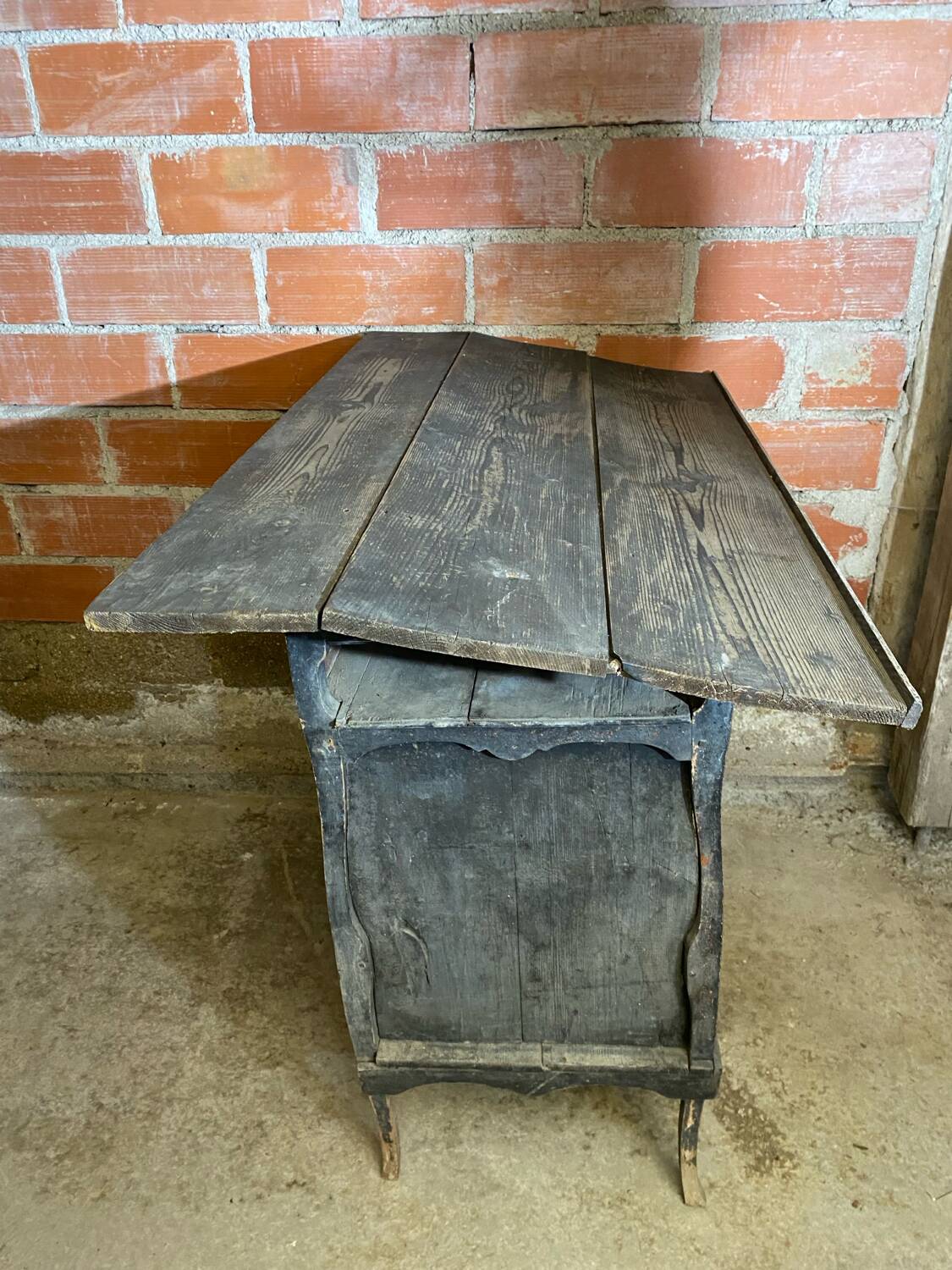 Antique writing desk, blackened wooden filing cabinet.