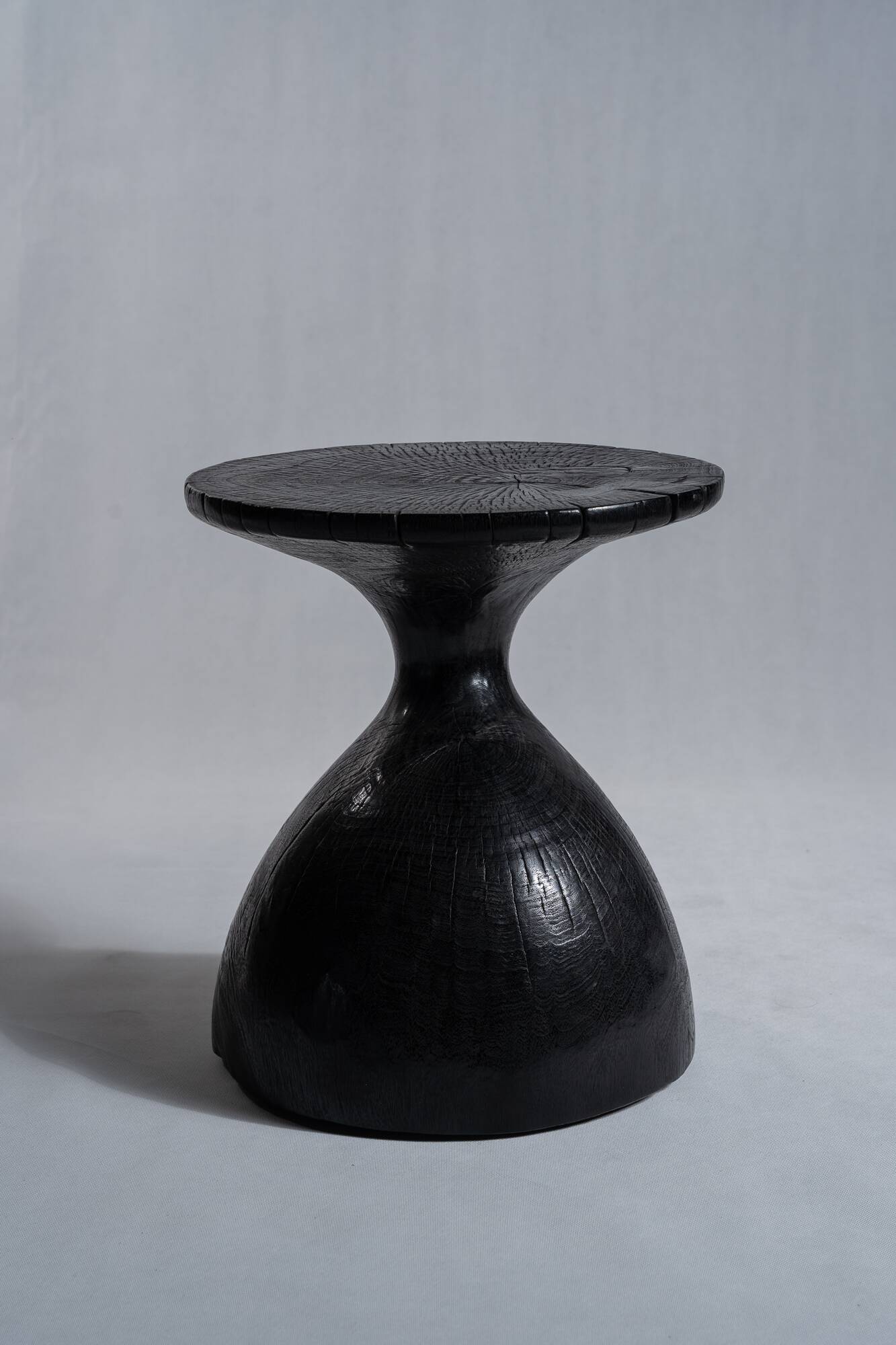 Solid wood (monoxyl) side table, organic shape, black color