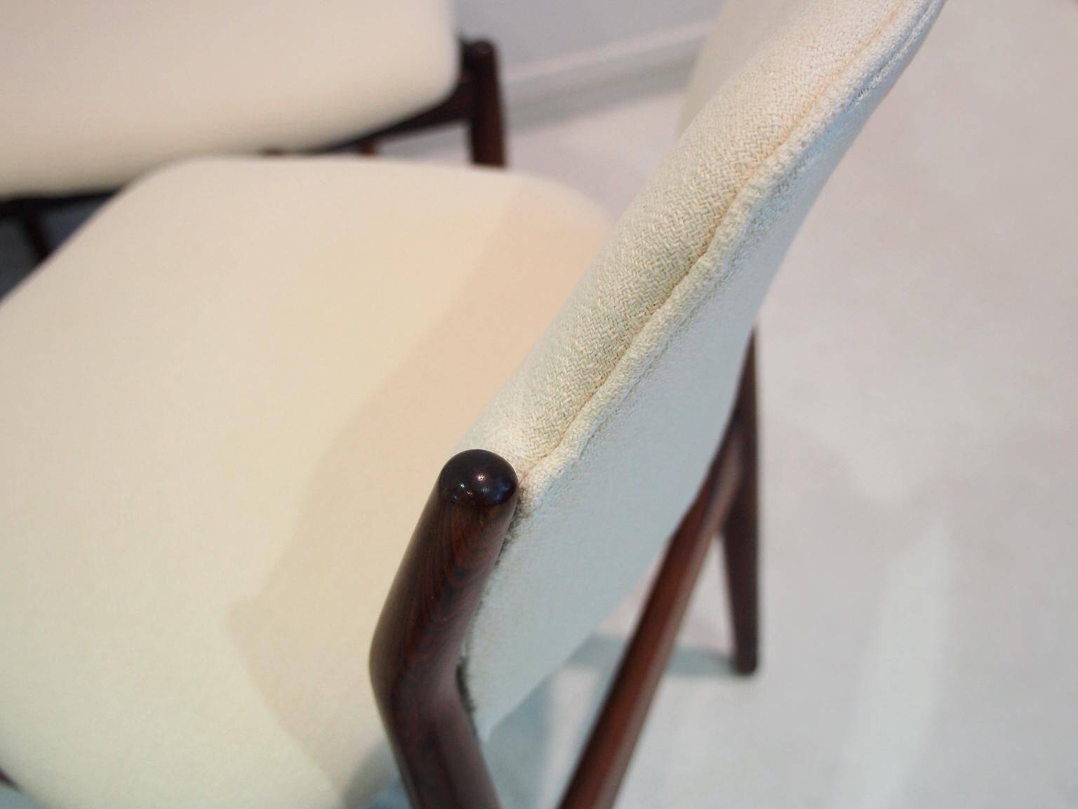 Set of six hardwood chairs by Arne Vodder for Sibast with white textile upholstery.
