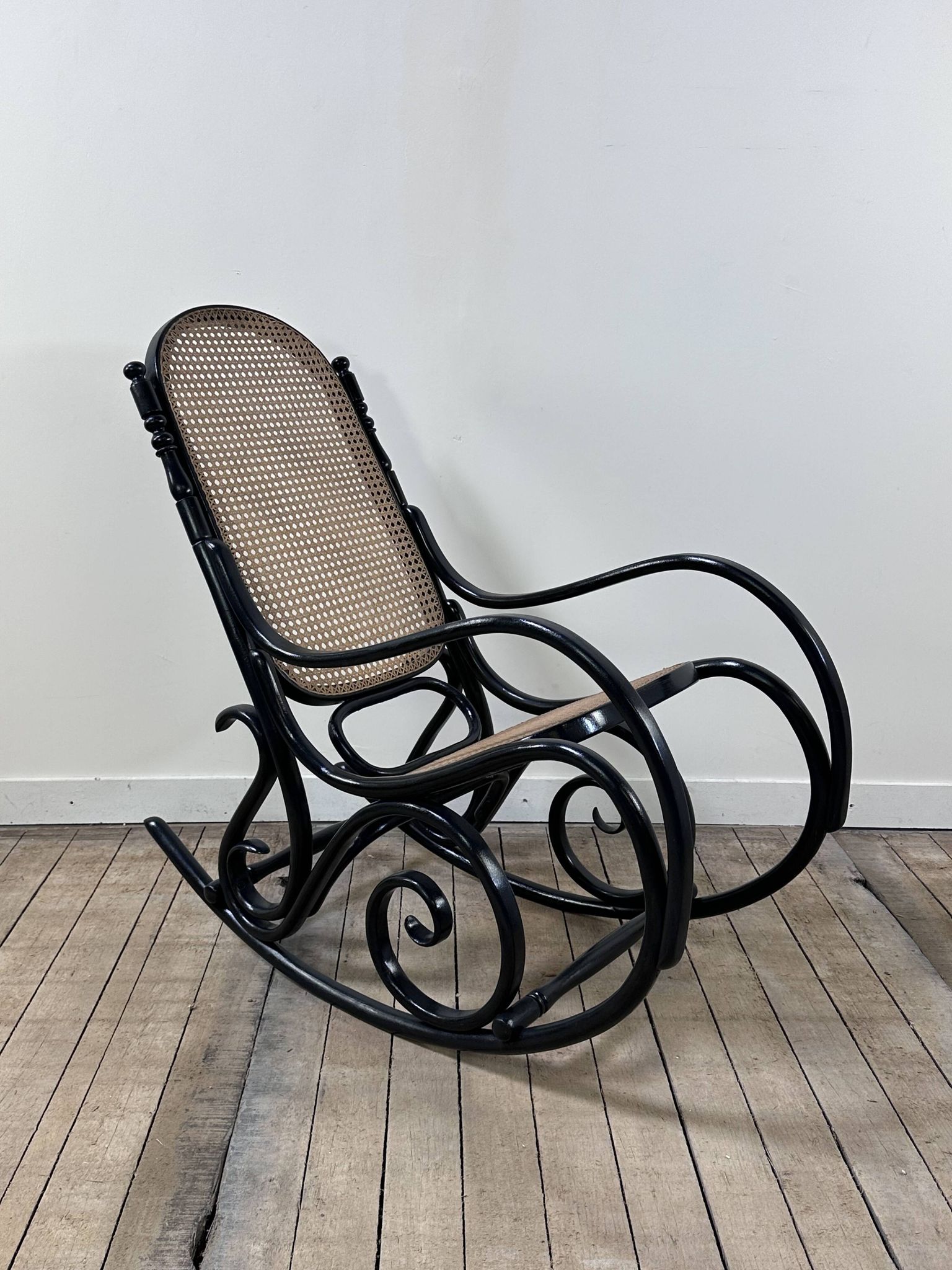 Rocking chair in blackened curved wood and cane, 1900s