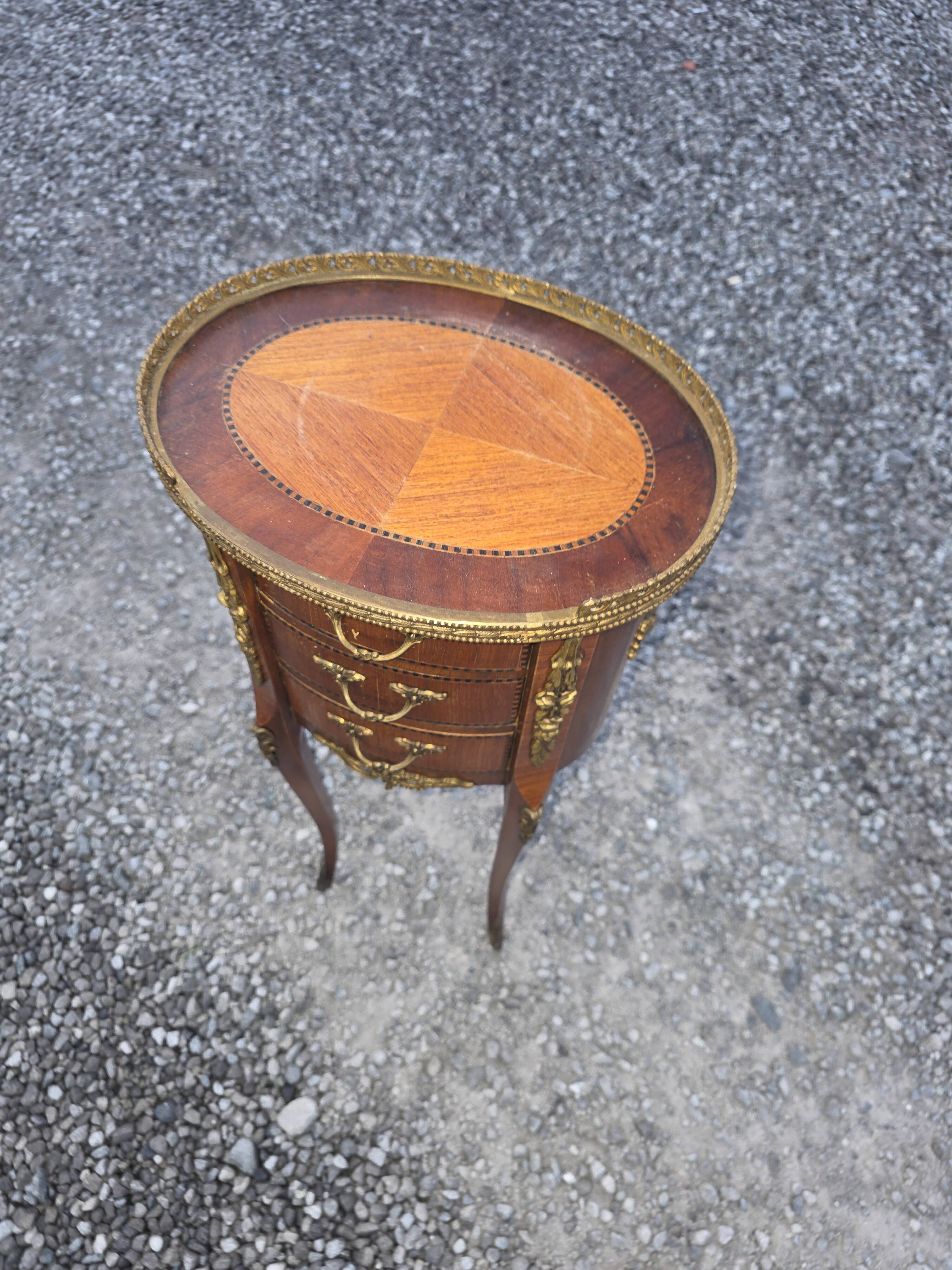 Oval bedside table in Louis XV style with marquetry.