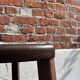 Nested tripod tables made of solid wood, in a modernist brutalist style.