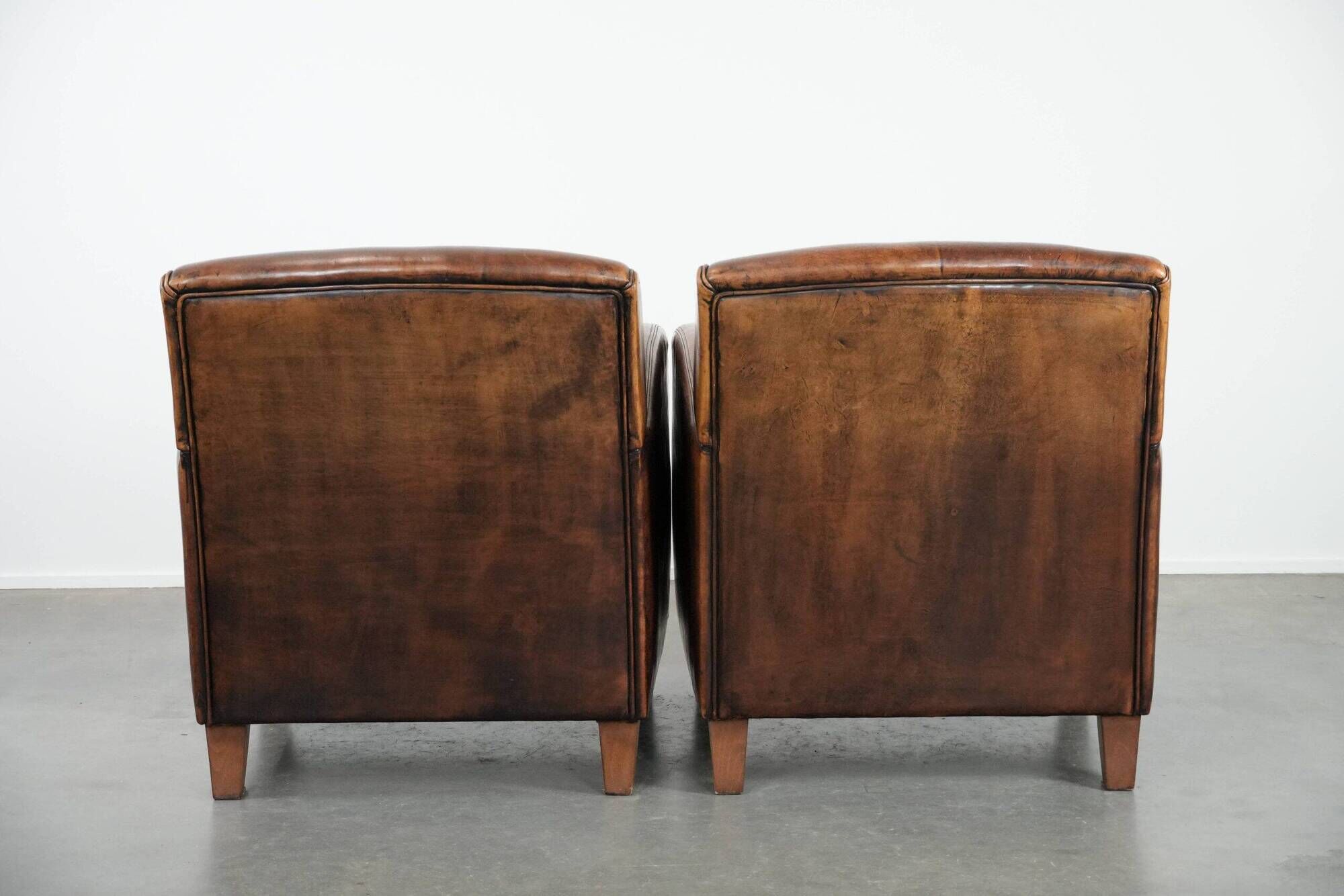 Characterful set of two vintage sheepskin armchairs with beautiful colours