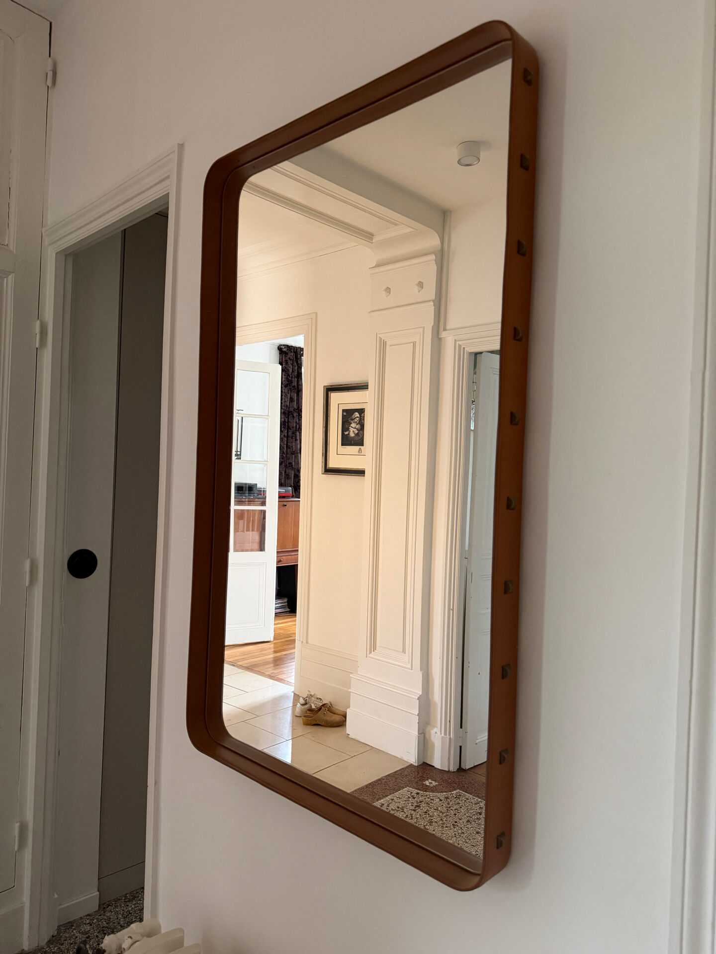Jacques Adnet mirror covered in cognac leather